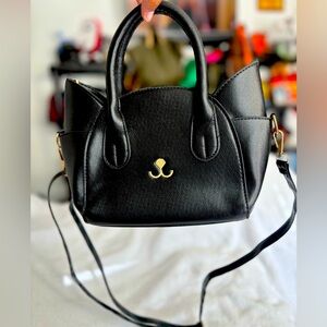 Black Cat Crossbody handbag with detachable strap.